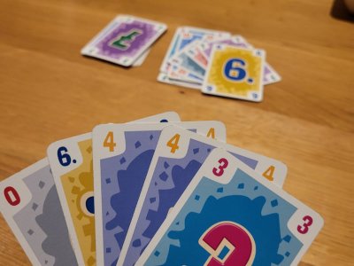 Buntes Kartenspiel, bei dem Karten in einer Hand gehalten werden