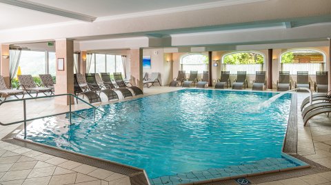 Hallenbad mit Massagedüse und vielen Liegestühlen