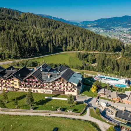 Hotel mit Blick auf Tal, Poollandschaft und umliegende Berglandschaft
