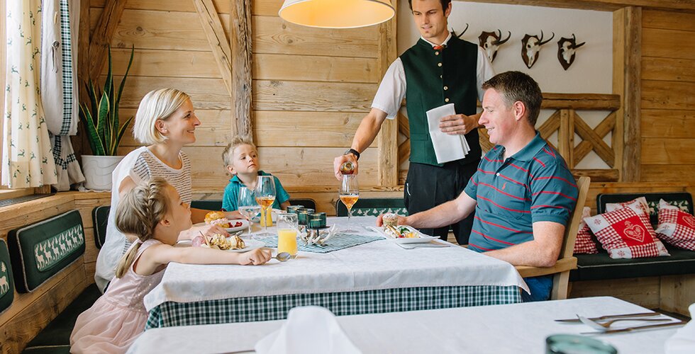 Kellner serviert einer Familie Essen