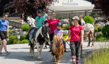 Pony hike with children and guides near the hotel stable.